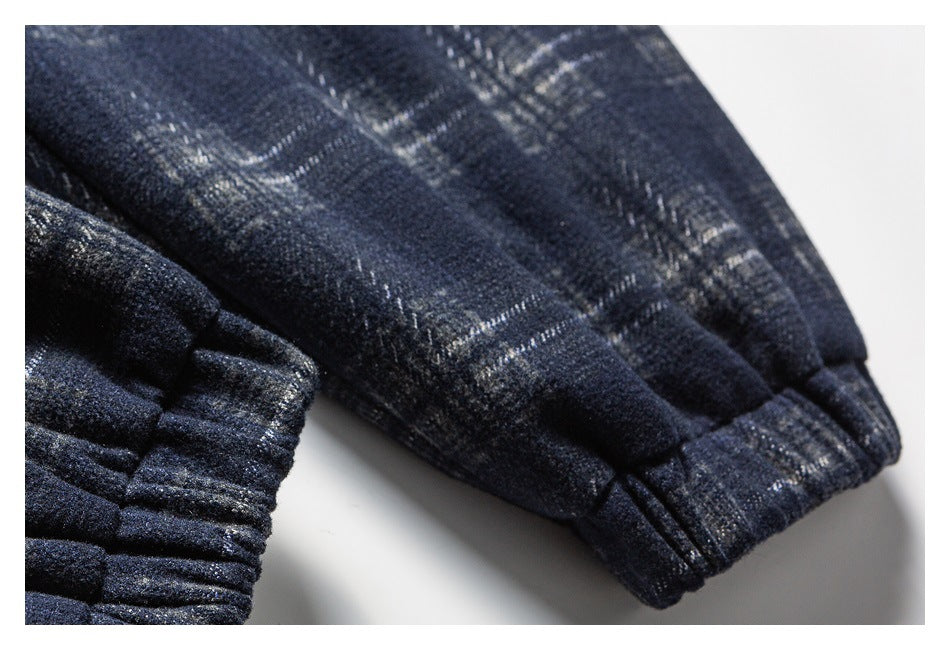 Close-up of the dark navy plaid jacket's sleeve and gathered elastic cuff.