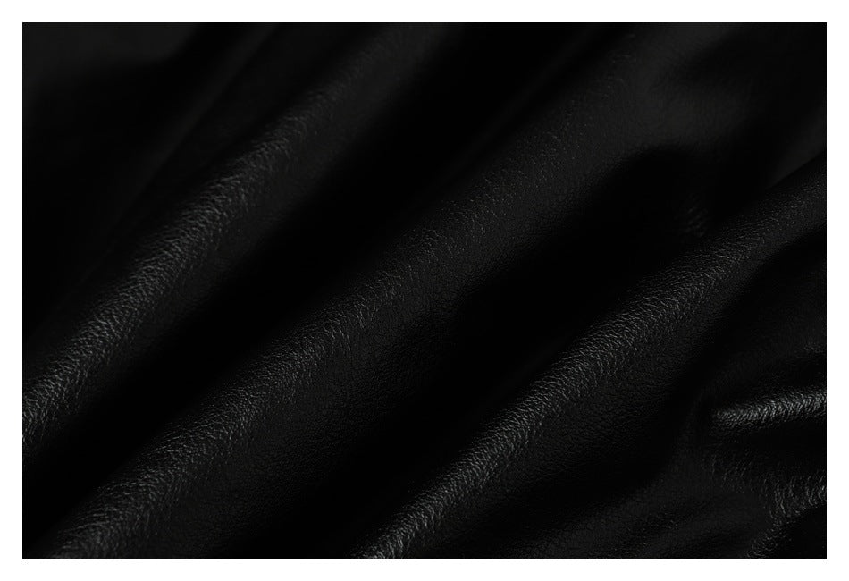 Extreme close-up showing the textured black surface and folds of the jacket.