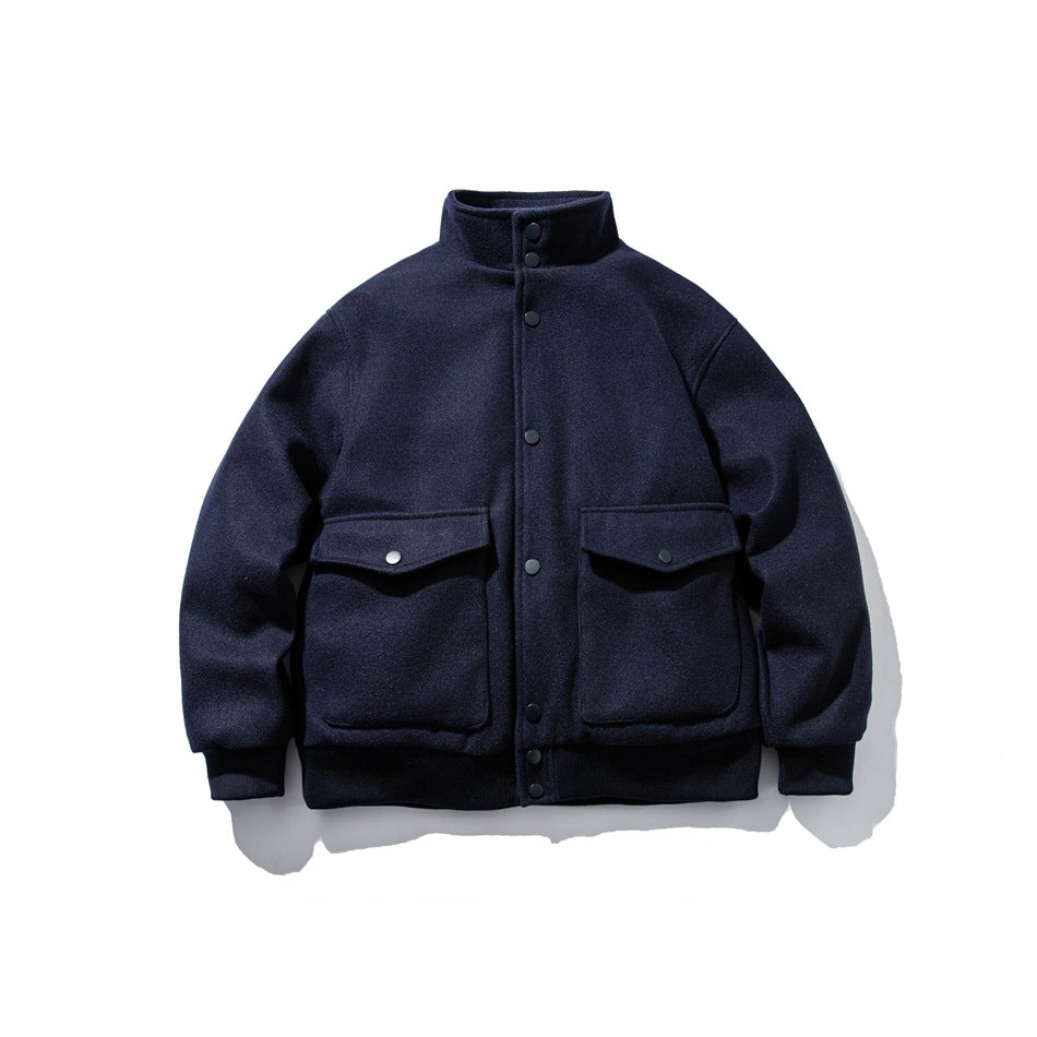 Navy blue stand-collar snap-front jacket with two large flap pockets and ribbed cuffs and hem, flat lay front view