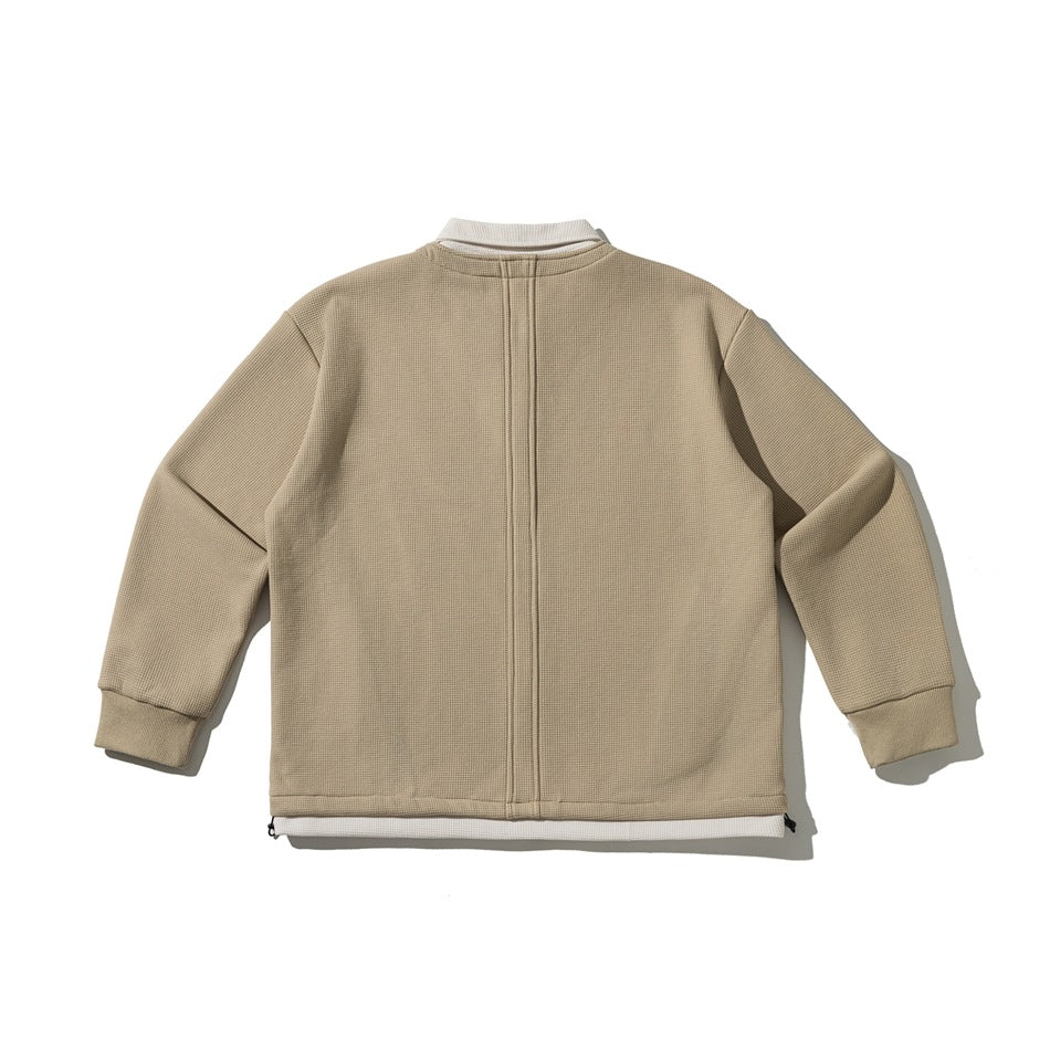 Back view of a tan pullover with a cream collar and hem accent, center seam, ribbed cuffs and hem drawcords.