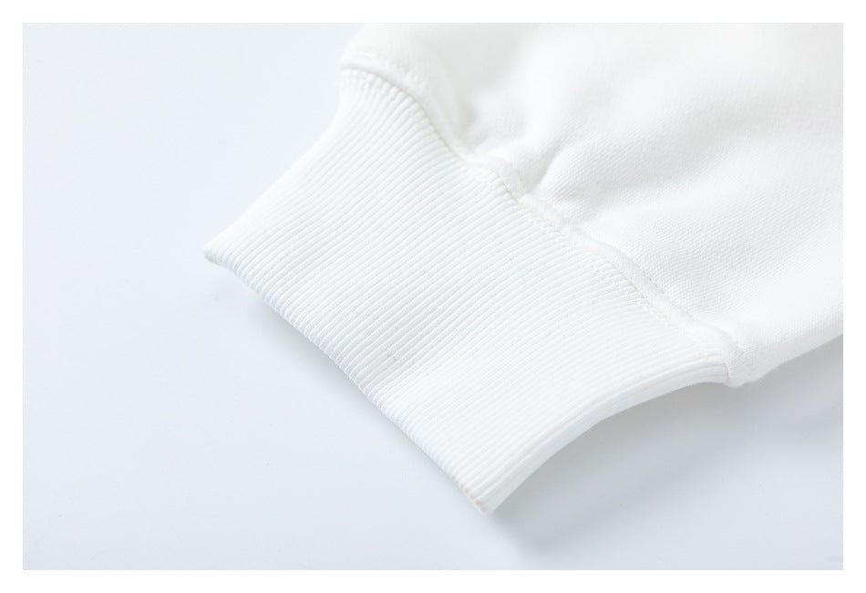 Close-up of a white garment sleeve ending in a wide ribbed cuff.