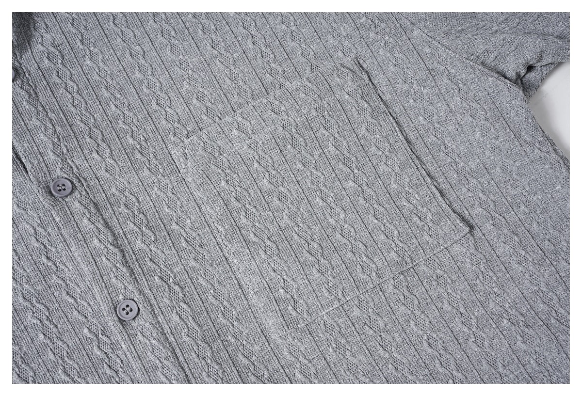 Close-up of the gray knit shirt's front, with two buttons and a stitched chest pocket.
