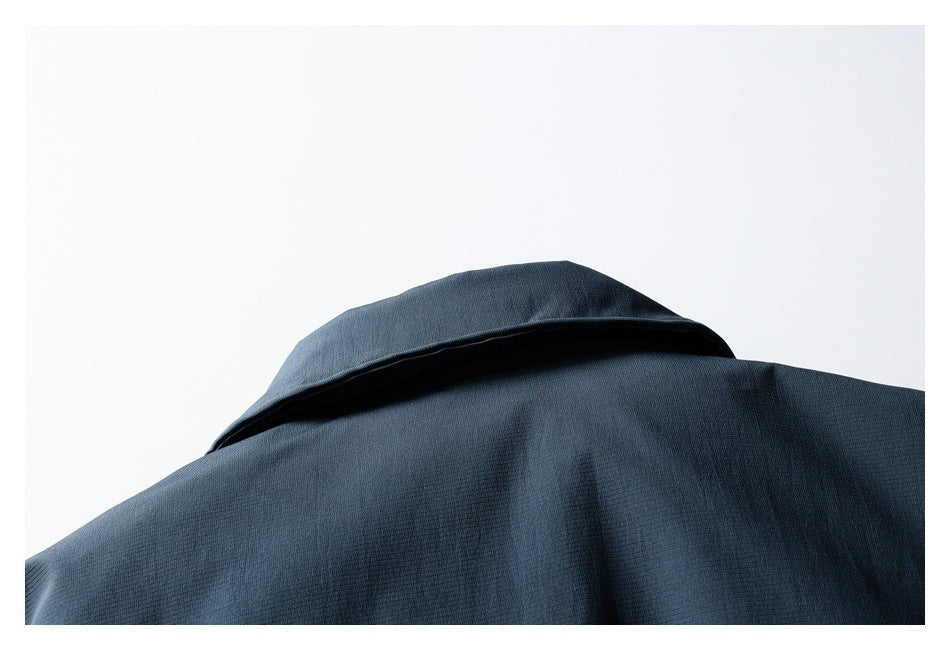 Close-up of the collar and upper back of a dark blue garment.