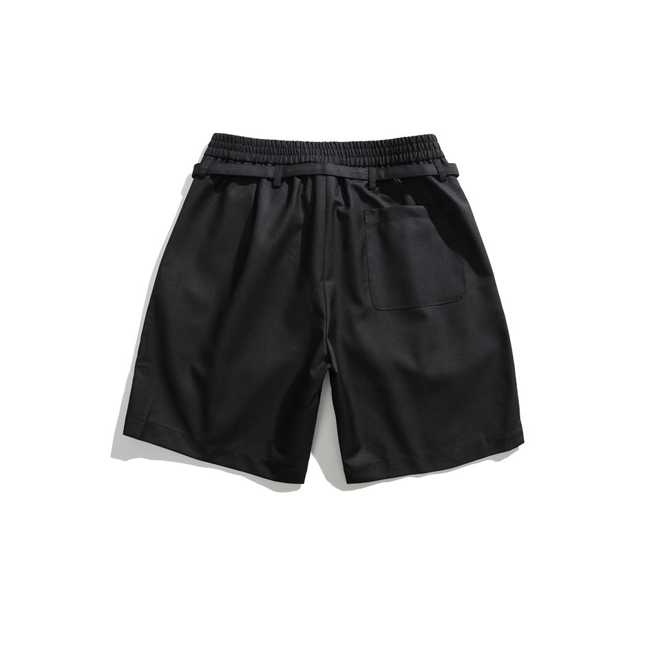 Back view of black shorts with elastic waistband, belt loops and a patch pocket, flat lay
