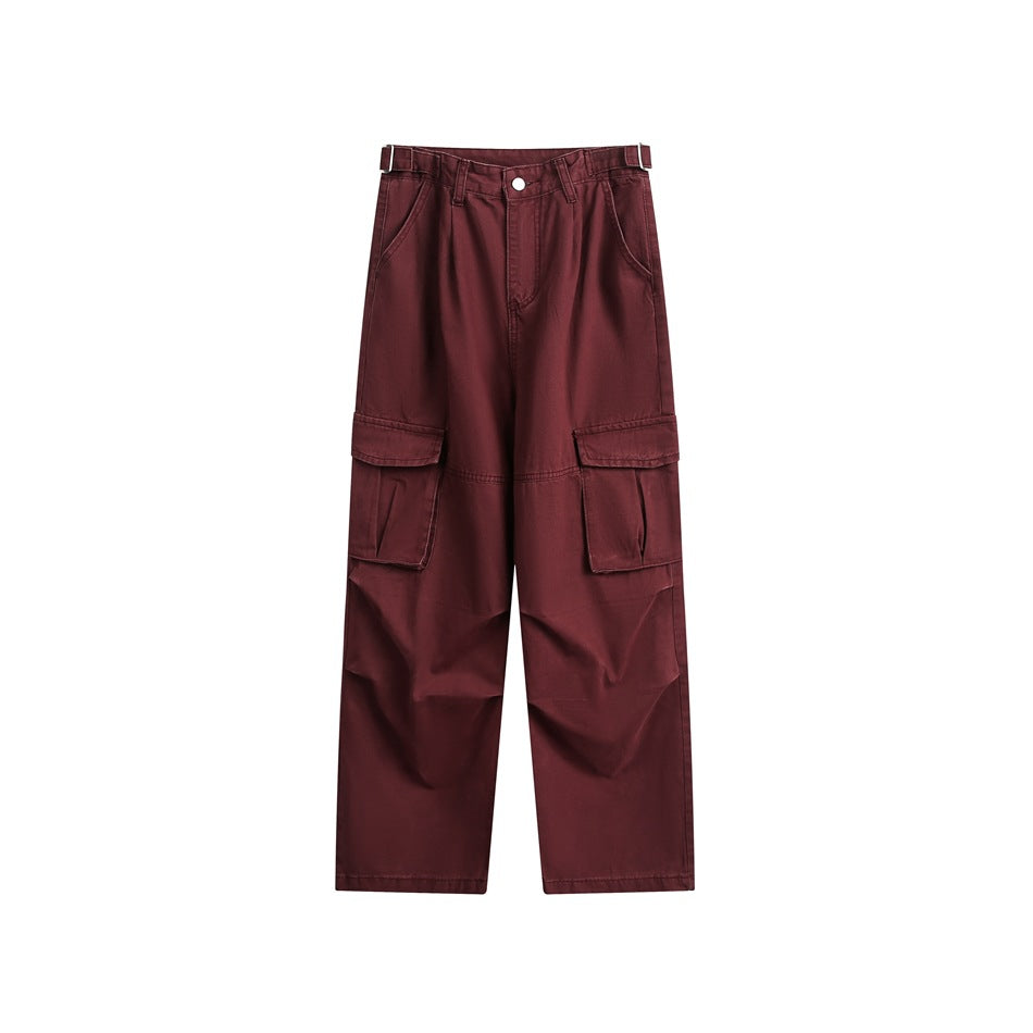 Burgundy wide-leg cargo pants, front view, with flap cargo pockets and side waist buckle tabs