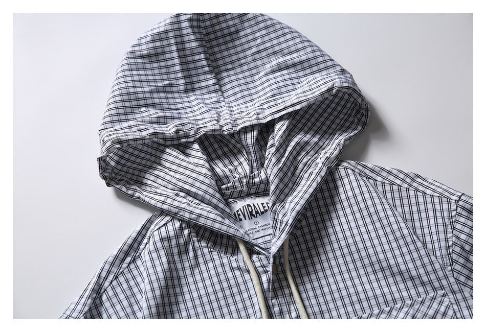Close-up of the checked shirt's hood, drawstrings and inner neck label.