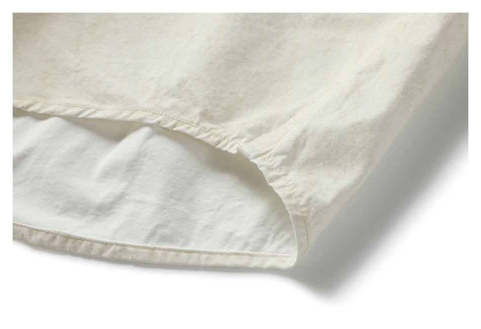 Close-up of the shirt's curved hem seam and side construction.