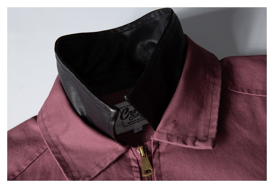 Close-up of a mauve jacket's pointed collar, black inner collar, and gold-tone zipper pull.