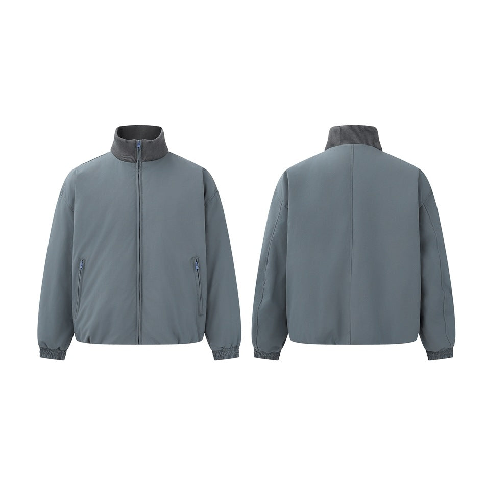 Slate blue-gray zip jacket shown from the front and back, with a ribbed stand collar, two front zip pockets, and elastic
