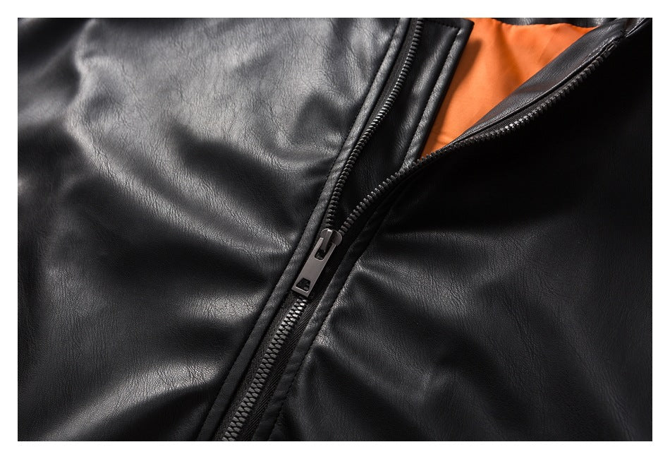 Close-up of a black jacket zipper with a glimpse of bright orange lining.