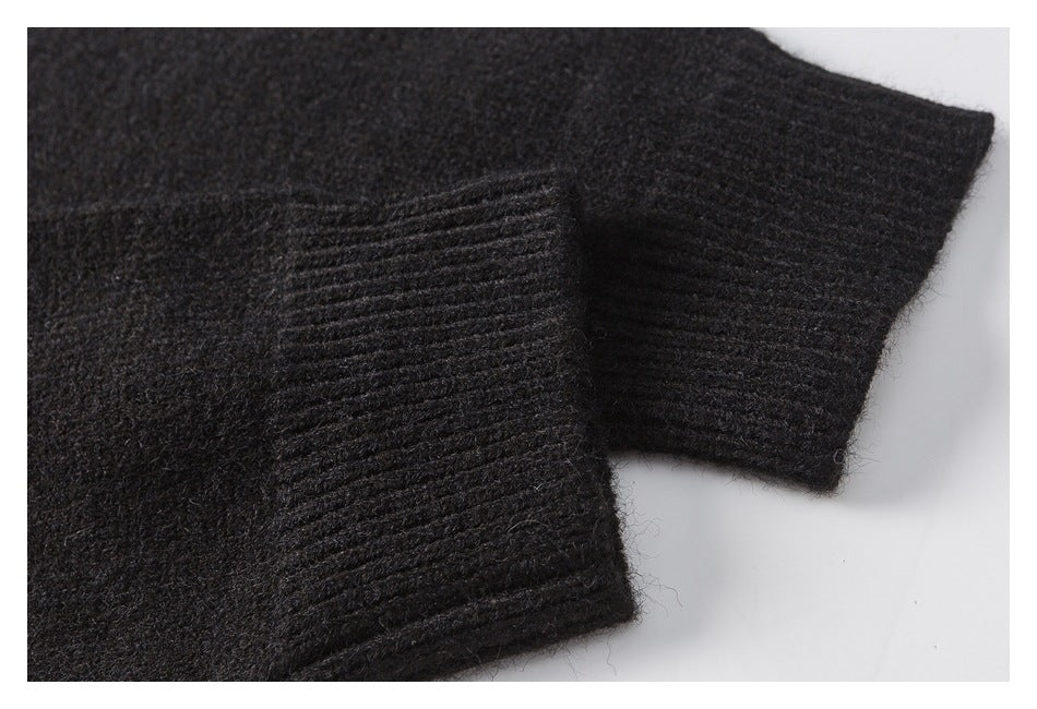 Close-up of a black fuzzy knit garment showing a ribbed cuff or hem edge.