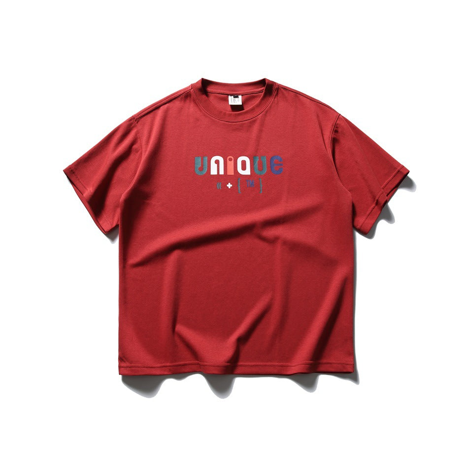 Red short-sleeve crew-neck T-shirt with multicolor UNIQUE graphic on the chest, flat lay front view