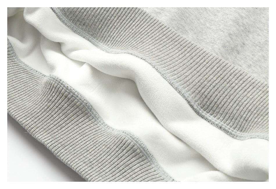 Close-up showing the soft white interior and ribbed trim of a light heather-gray garment.