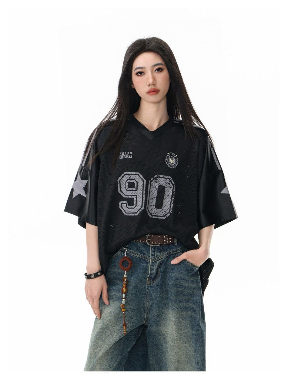 Front view of a model in an oversized black mesh jersey with gray 90 and star sleeve graphics.