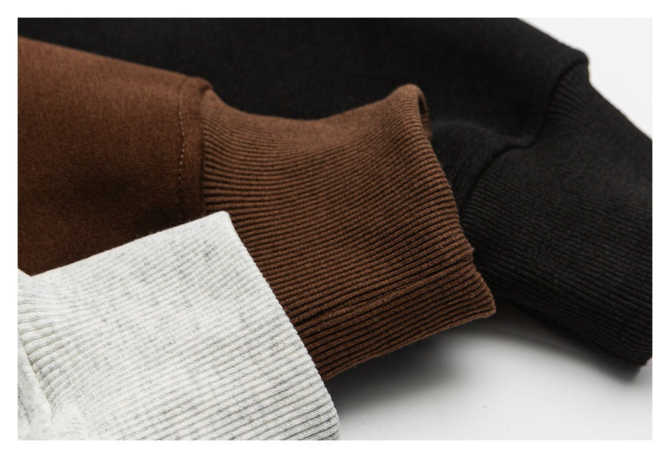 Close-up of ribbed sweatshirt cuffs in black, brown, and light gray.