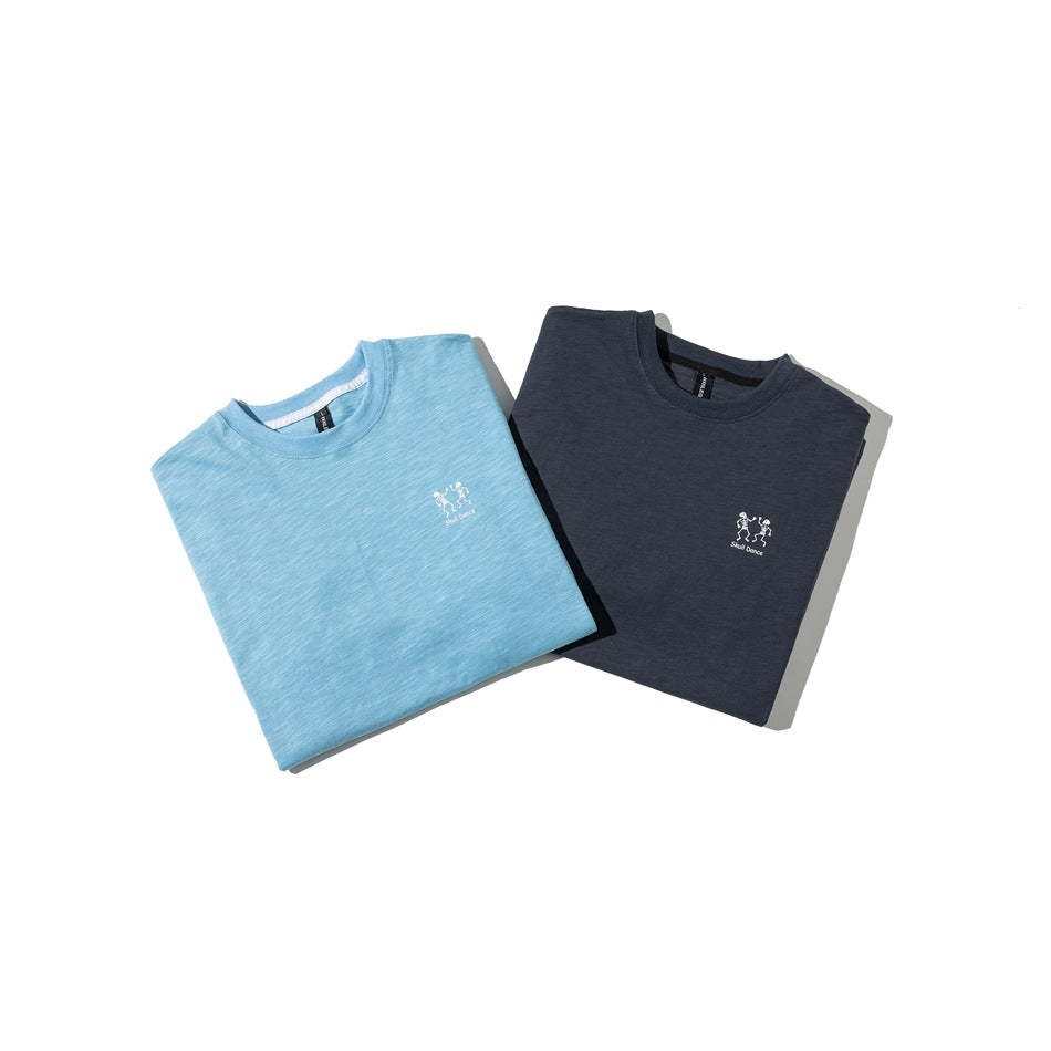 Folded light blue and dark navy crew-neck T-shirts, each with a small white dancing skeleton chest graphic.