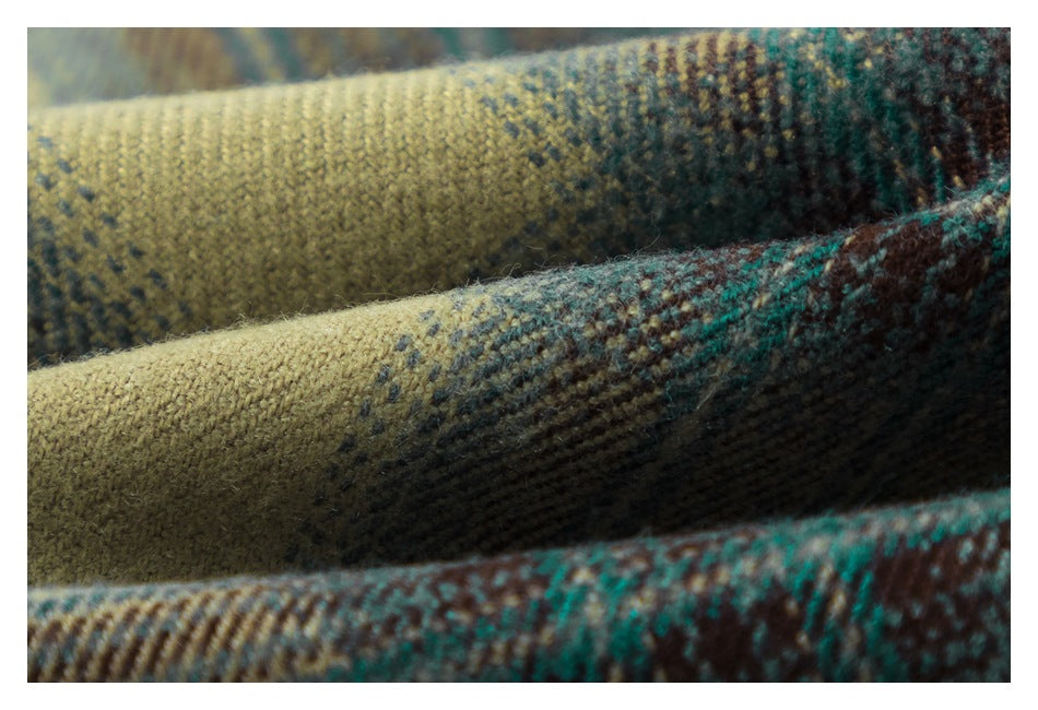 Macro view of the textured weave and plaid colors in tan, teal, and brown.