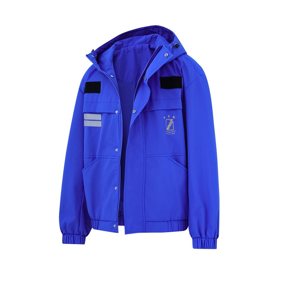 Front view of a bright blue hooded jacket with flap pockets, black patches, reflective strips and small chest emblem.
