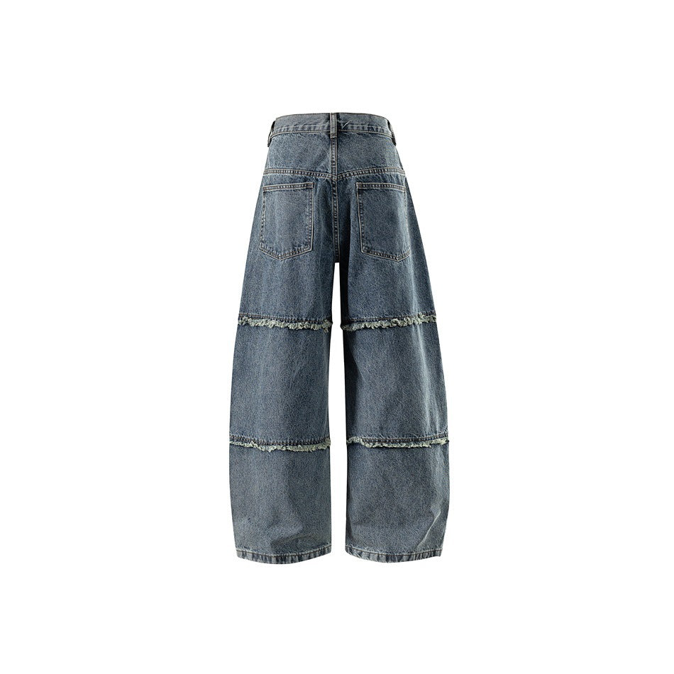 Back view of washed blue wide-leg jeans with two patch pockets and frayed horizontal seam bands on the legs