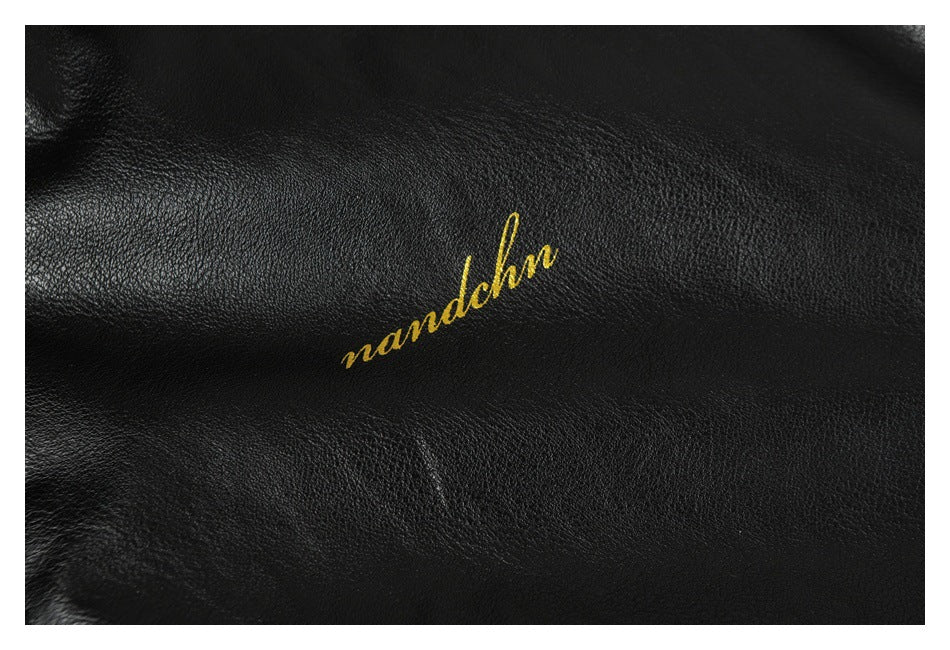 Close-up of gold cursive lettering on the black jacket surface.