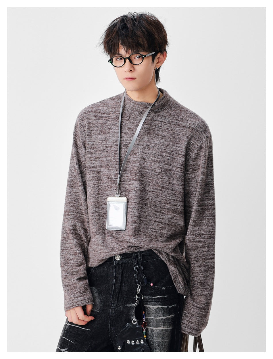 Model wearing a brown marled mock neck long-sleeve top with black washed jeans