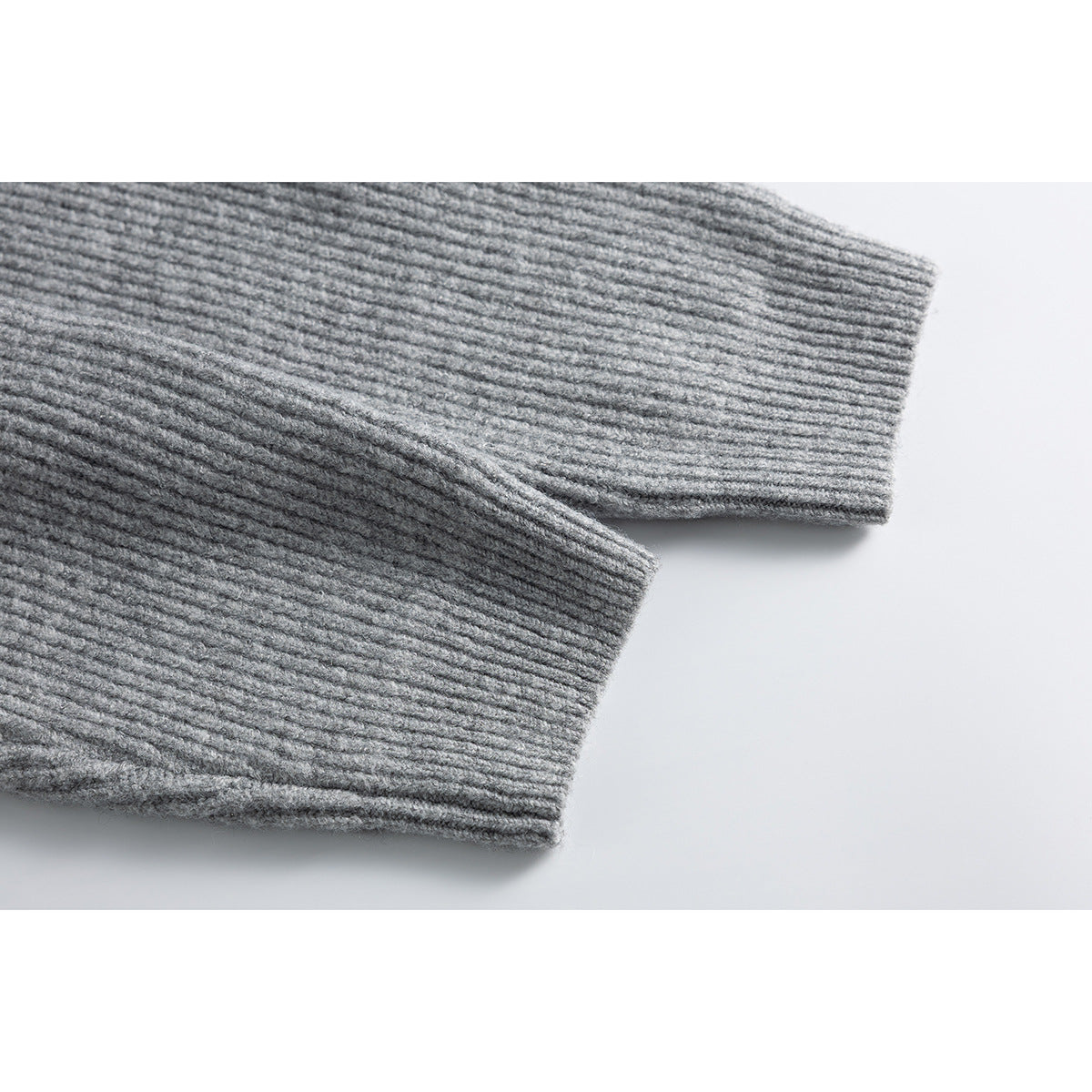 Close-up of the gray ribbed cardigan's long sleeves and cuffs.