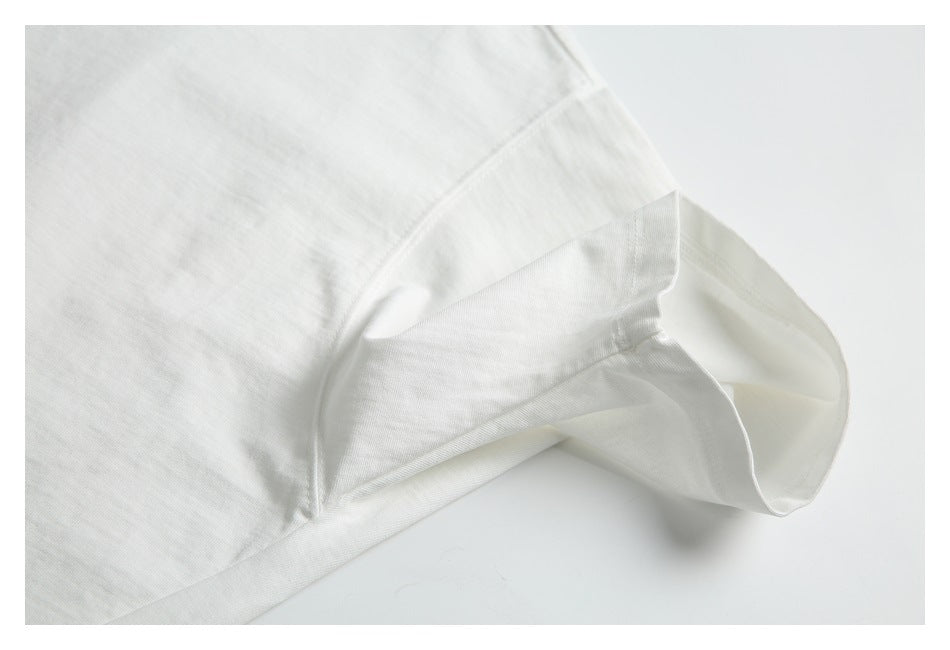 Close-up of the sleeve and underarm seams of a white T-shirt.