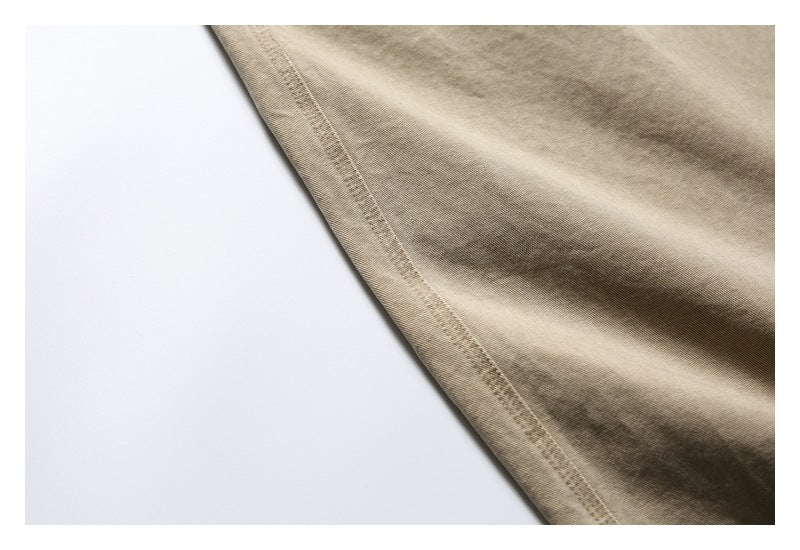 Close-up of a stitched seam along the khaki trouser leg.