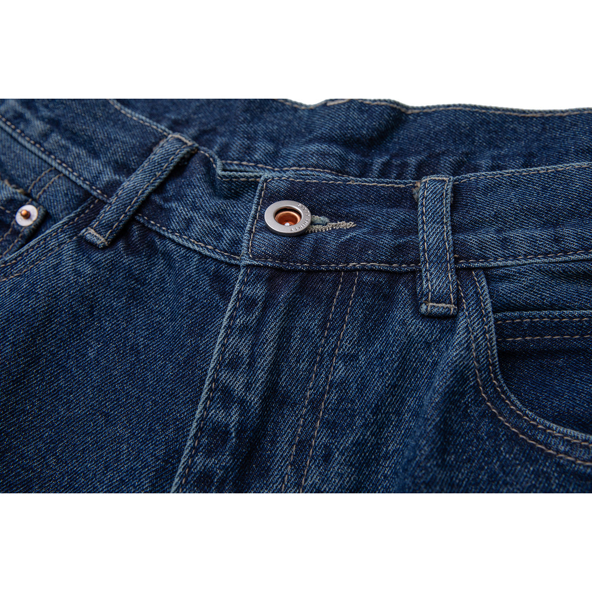 Close-up of dark blue jeans showing the waistband button, belt loops, and contrast stitching.