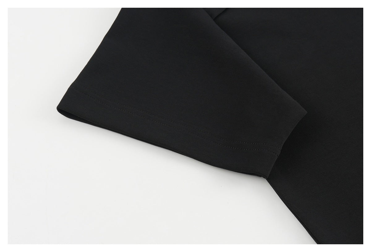 Close-up of a black shirt sleeve with a double-stitched hem.