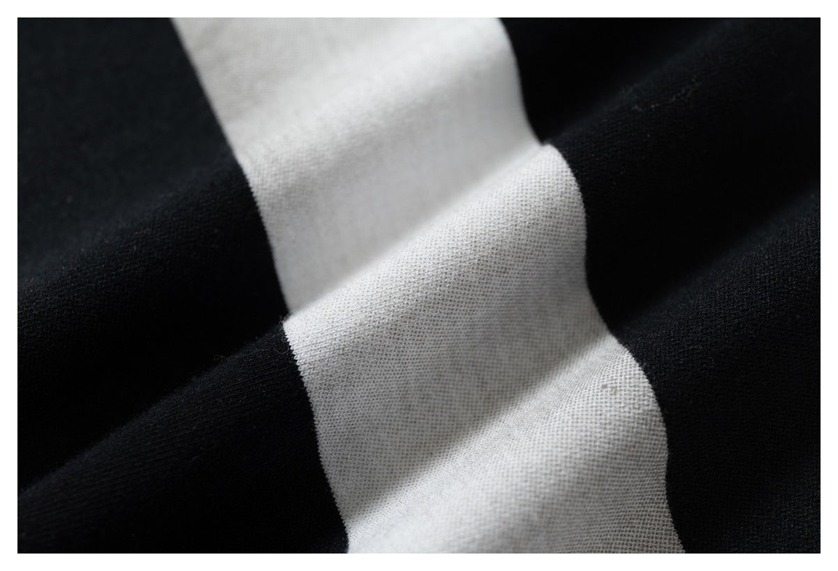 Extreme close-up showing the knit texture and folds of the black-and-white striped fabric.
