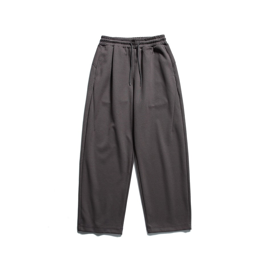 Dark gray drawstring sweatpants with wide straight legs, laid flat, front view