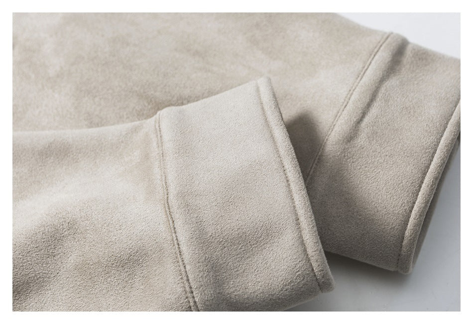 Close-up of the taupe jacket's folded sleeve cuff and stitched seam.