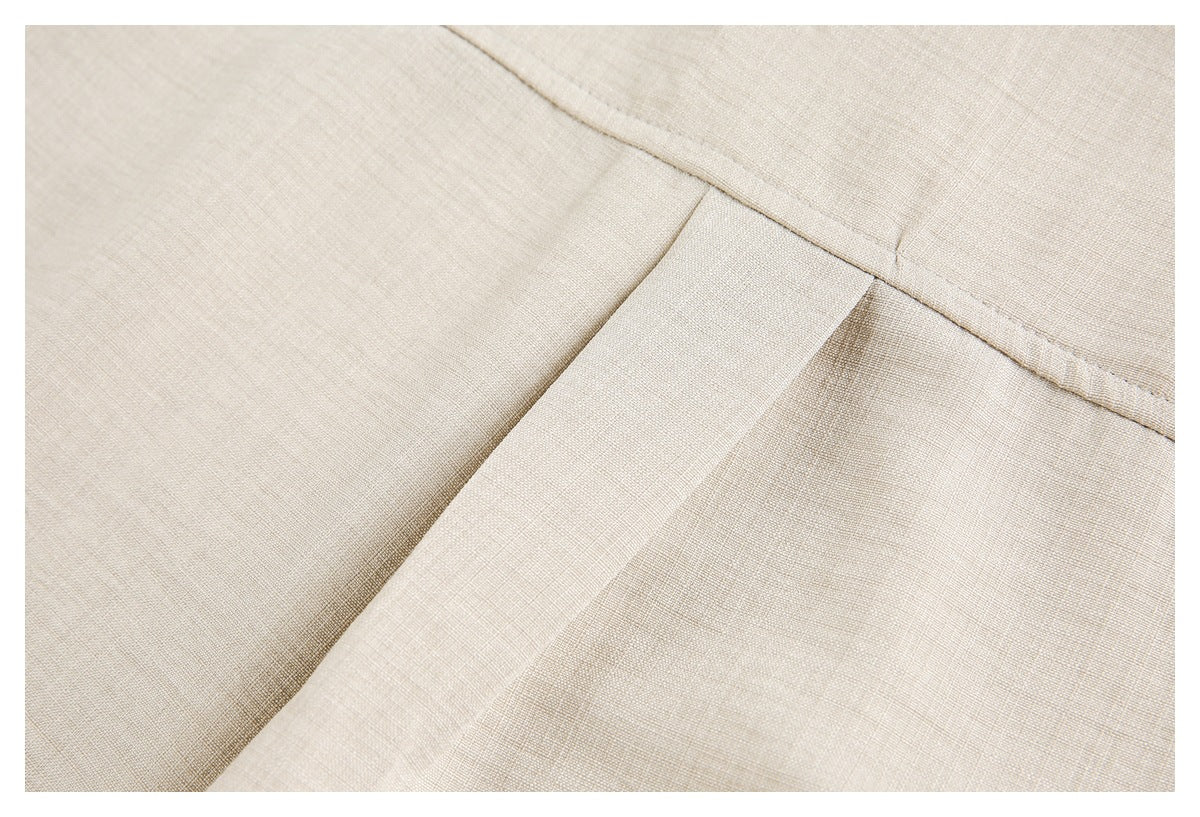 Close-up of a beige garment pocket flap and surrounding stitching.