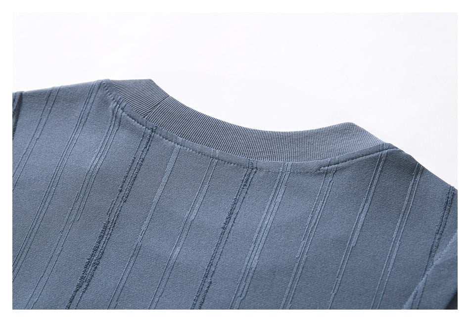 Close-up of the blue-gray top's ribbed round neckline and upper back with vertical stripes.