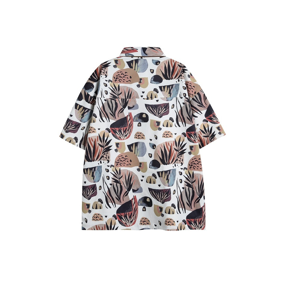 Front view of a short-sleeve collared shirt with an allover abstract botanical print on a light background.