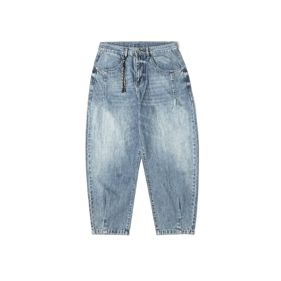 Light blue faded-wash barrel-leg jeans flat lay, front view, with braided cord hanging from the belt loop