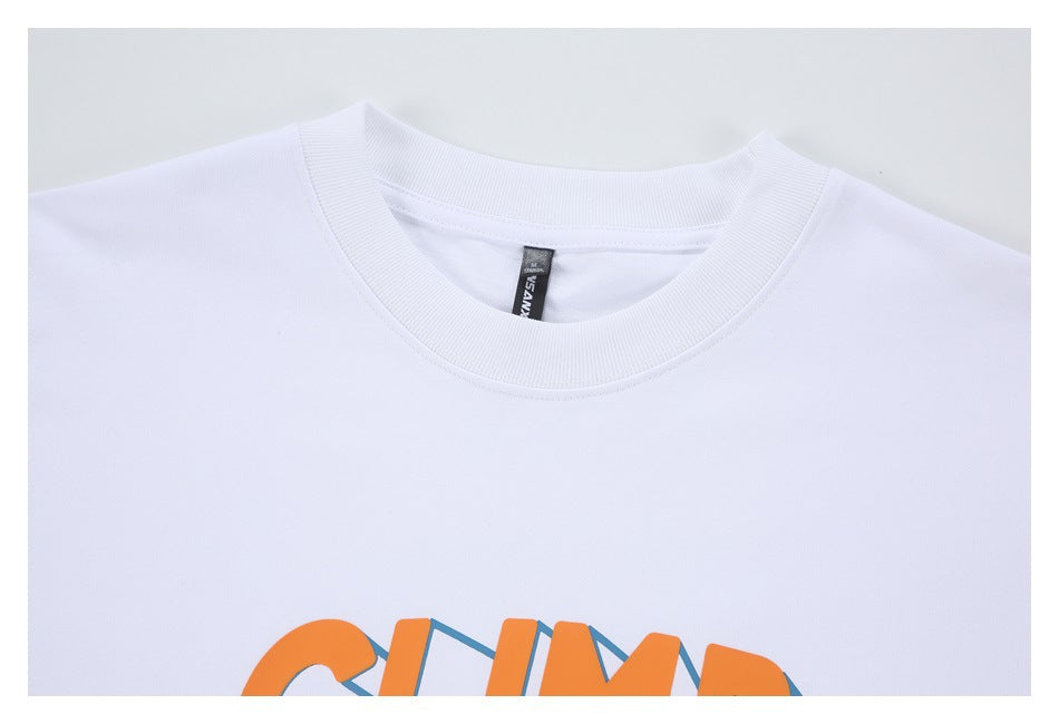 Close-up of a white crew-neck T-shirt collar with part of an orange and blue printed graphic visible.
