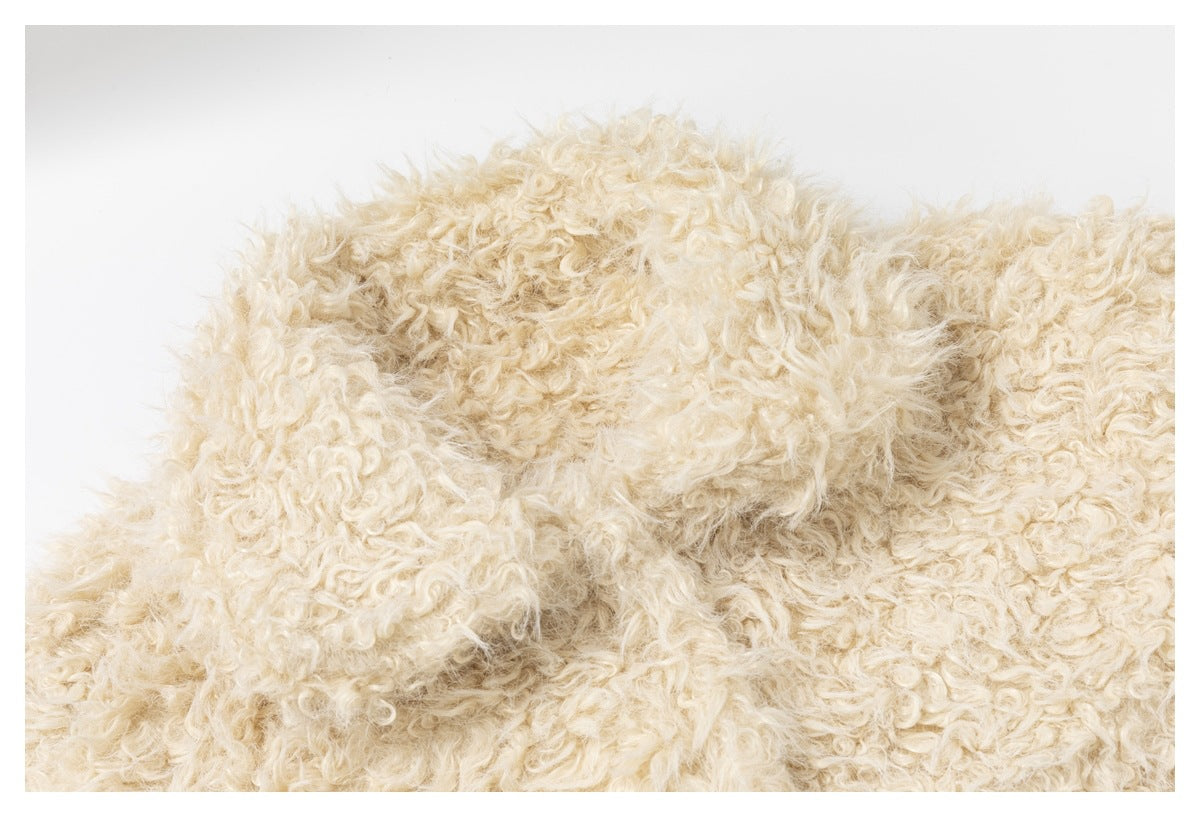 Close-up of dense, curly cream-colored pile fabric.