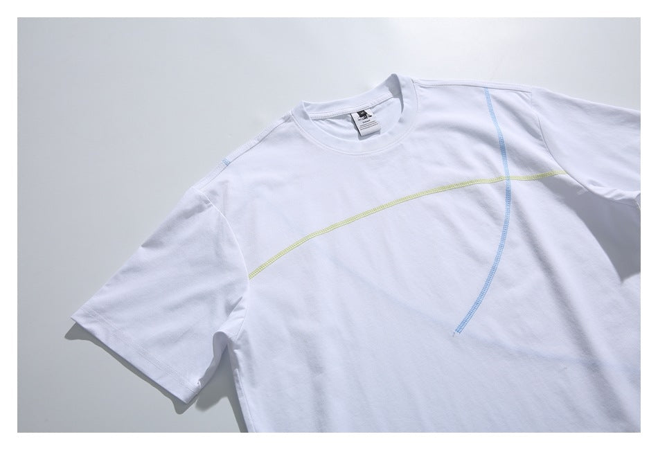 Angled front view of a white short-sleeve T-shirt with curved lime and blue seam details.