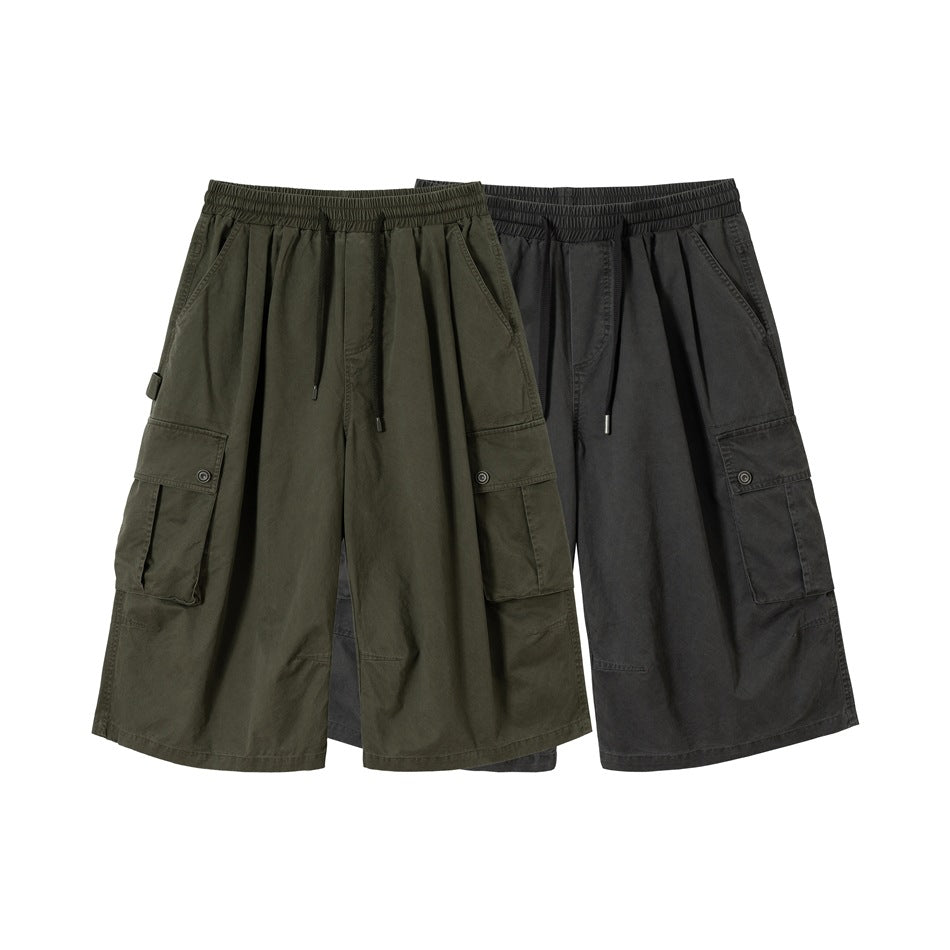 Front view of wide-leg cargo shorts in olive and charcoal, with elastic drawstring waists and button-flap side pockets.