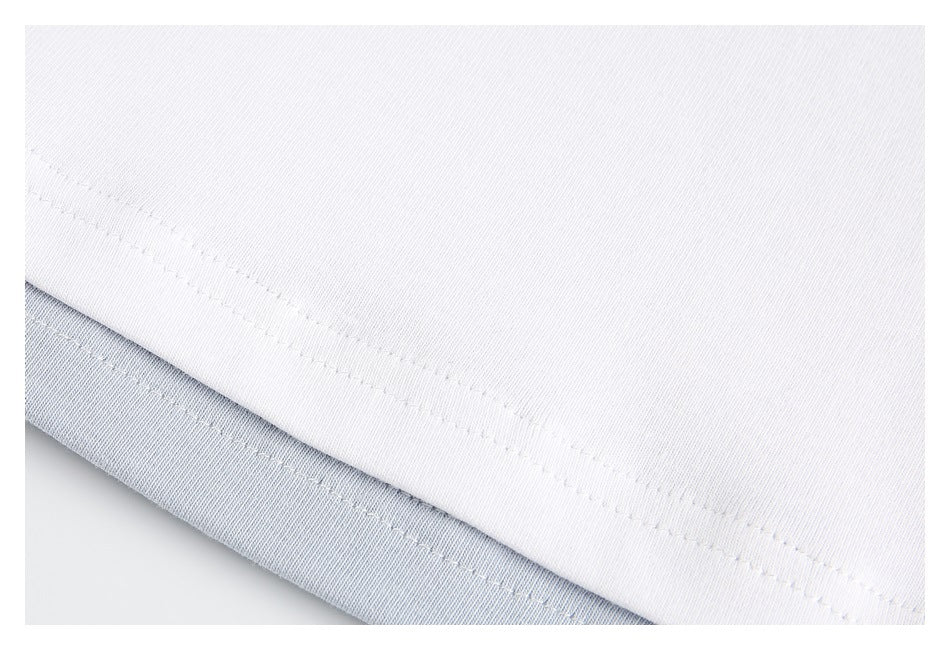Close-up of the stitched hem on a white shirt, with pale blue fabric visible underneath.