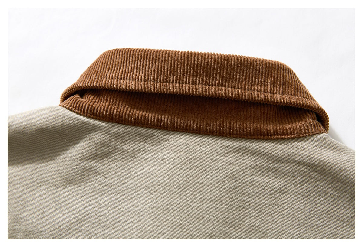 Close-up of a brown corduroy collar against beige jacket fabric.