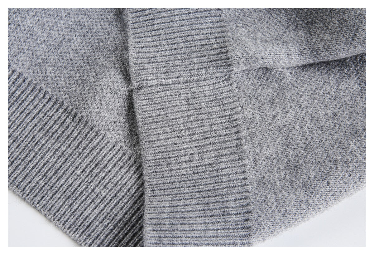 Close-up of a heather gray knit garment showing ribbed trim beside a smooth knit panel.