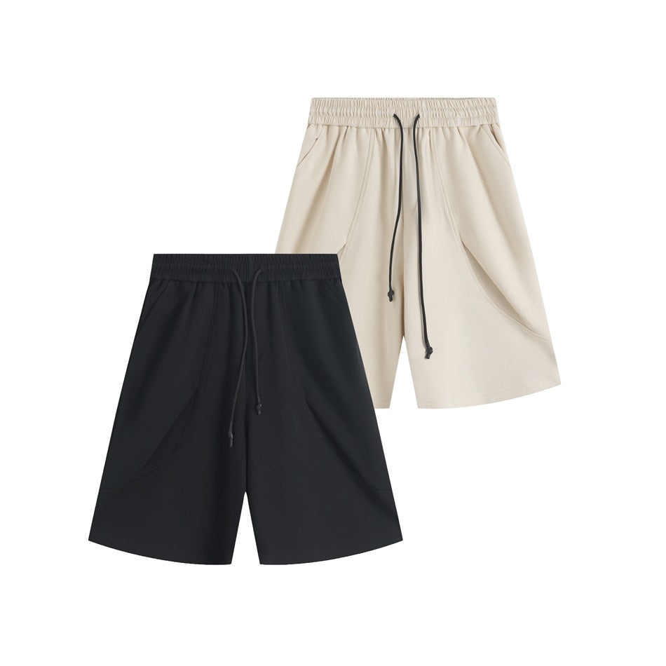 Front view of drawstring shorts in cream and black, displayed together on a white background.