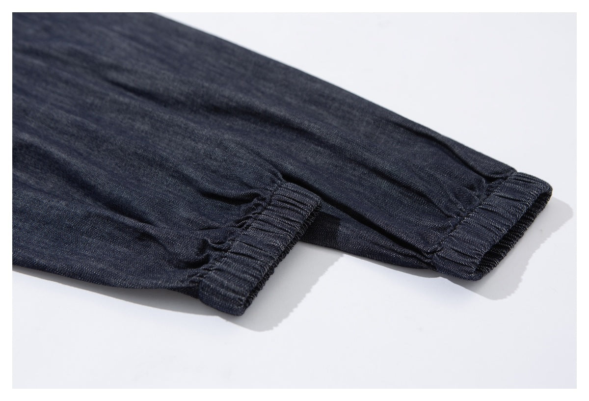Close-up of a dark indigo sleeve ending in a gathered elastic cuff.