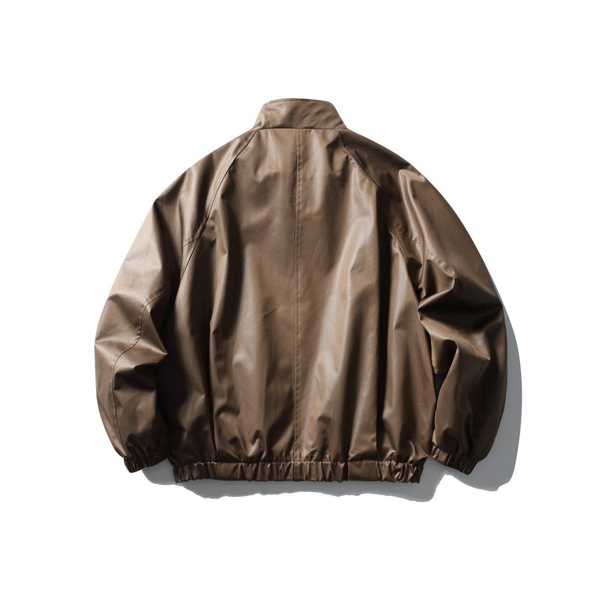 Back view of a dark brown jacket with a stand collar, raglan seams, and gathered cuffs and hem.
