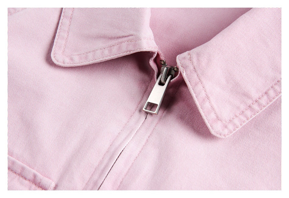 Close-up of the pink jacket's metal zipper, collar edges, and visible fabric weave.