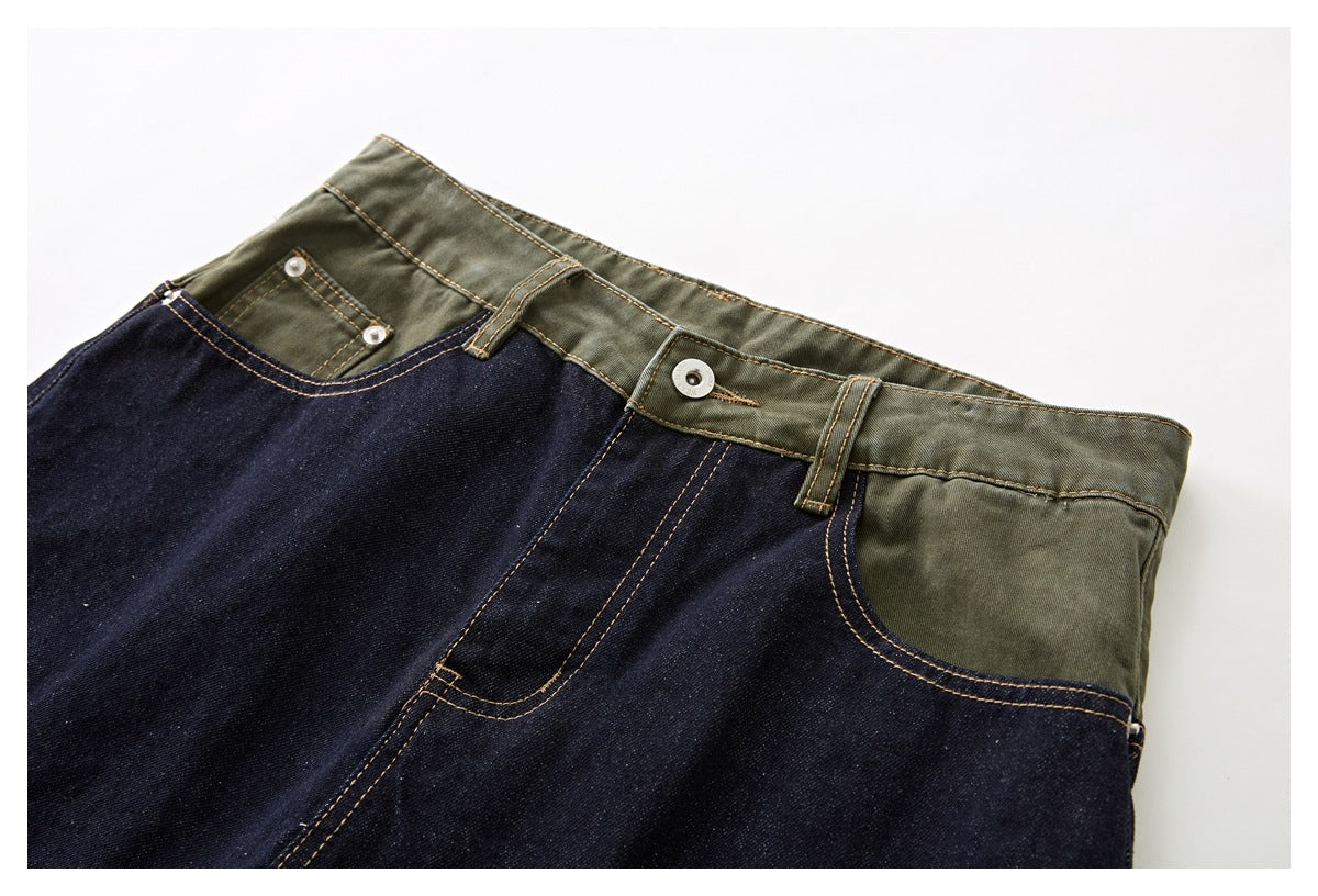 Close-up of dark indigo denim shorts with an olive-green waistband, front pockets, metal button and contrast stitching.