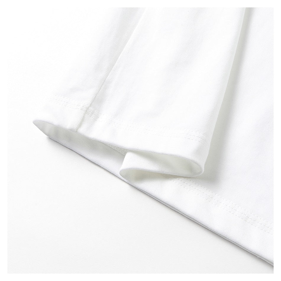 Close-up of a white shirt sleeve and body hems with visible double stitching.